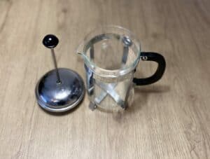 French Press with plunger on a table surface